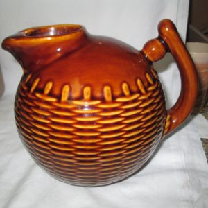 Really neat basket weave pattern round ball pottery pitcher Brown glazed with ice catcher