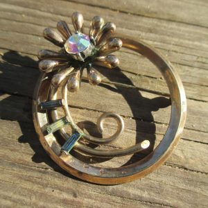 Beautiful Rhinestone round pin gold metal aurora boralis flower center with blue and clear bagettes vintage jewelry