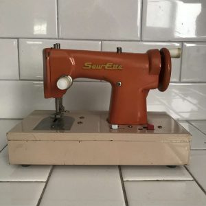 Child size SewEtte Orange and beige sewing machine hand crank & Battery operated Japan Metal 1940's collectible display all metal