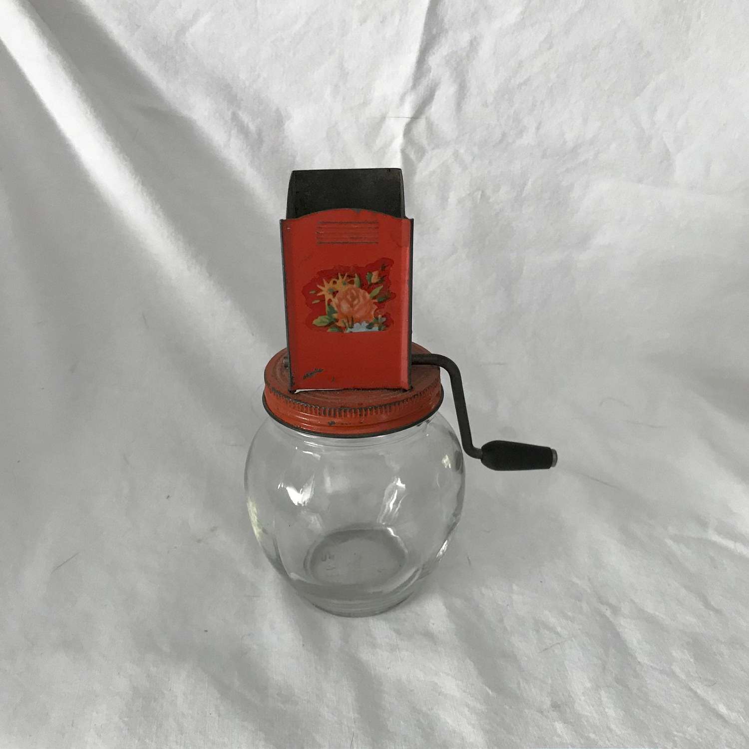 https://www.truevintageantiques.com/wp-content/uploads/2019/12/vintage-hazel-atlas-chopper-orange-flowers-black-wooden-handle-round-jar-base-nut-choper-1930-40s-farmhouse-cottage-5df2621f1-scaled.jpg