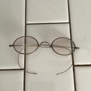 Antique eyeglasses Child size thin wire bows glass lenses wire rims collectible display farmhouse bed and breakfast turn of the century