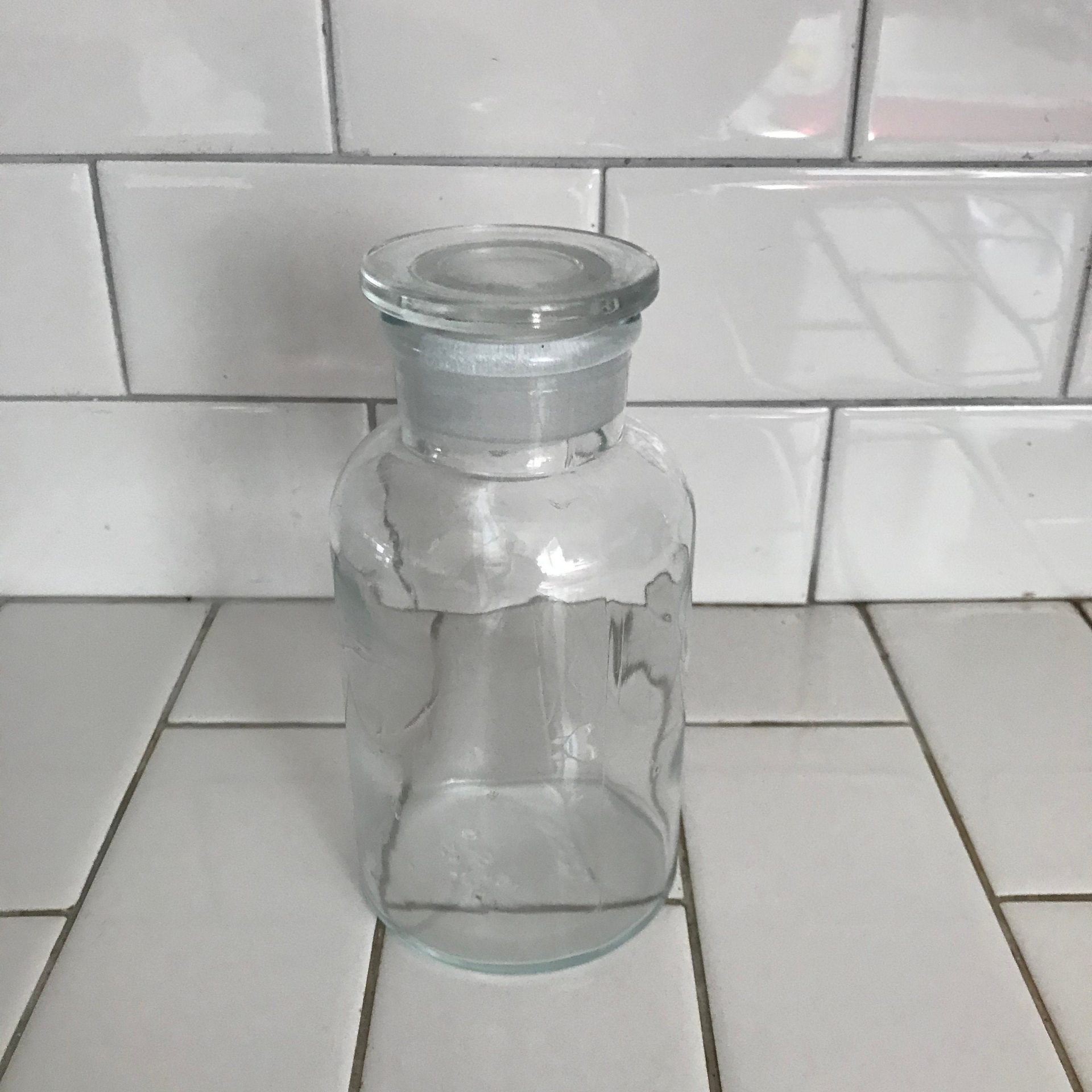https://www.truevintageantiques.com/wp-content/uploads/2021/05/vintage-apothecary-jar-medical-collectible-ground-glass-stopper-tcw-co-usa-clear-farmhouse-primitive-rustic-medical-pharmiceutical-bottle-60990b091-scaled.jpg