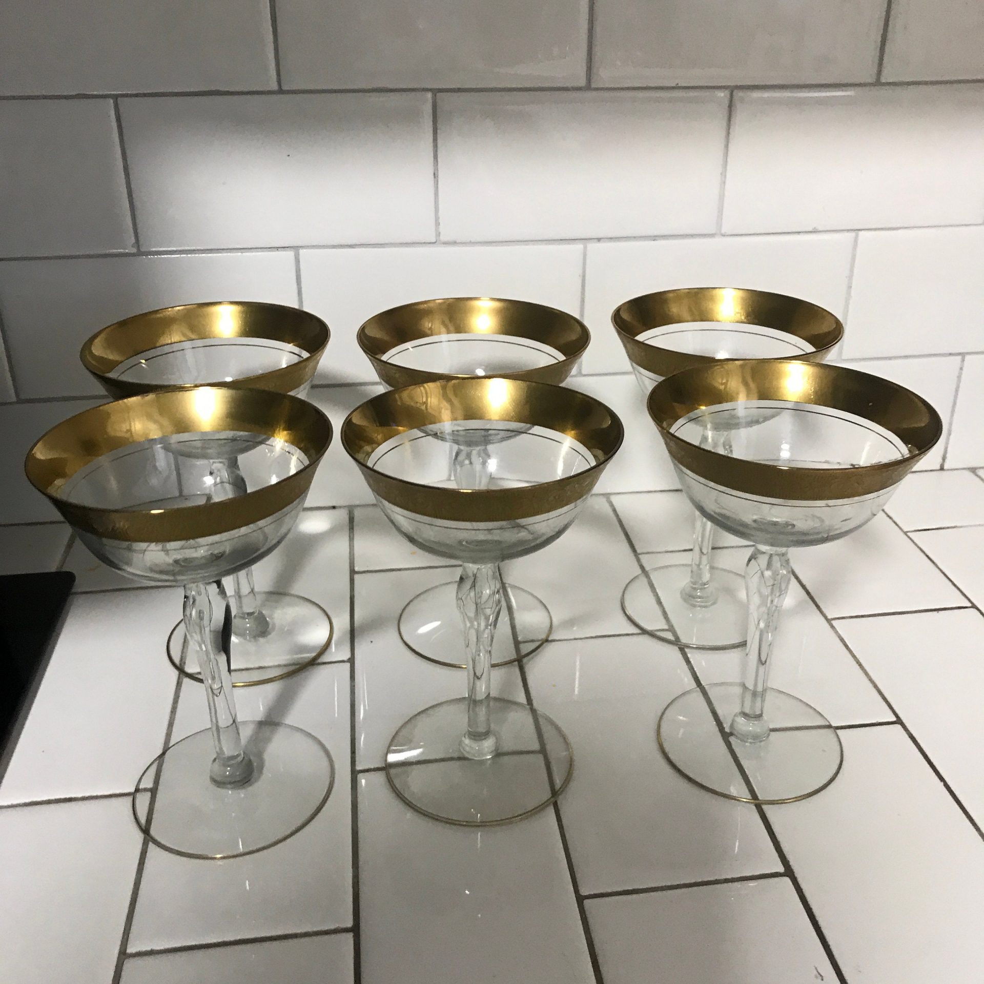 https://www.truevintageantiques.com/wp-content/uploads/2021/05/vintage-set-of-6-wine-glasses-shallow-champagne-paneled-crystal-with-heavy-gold-ornate-trim-display-collectible-evening-dining-6099095d2-scaled.jpg