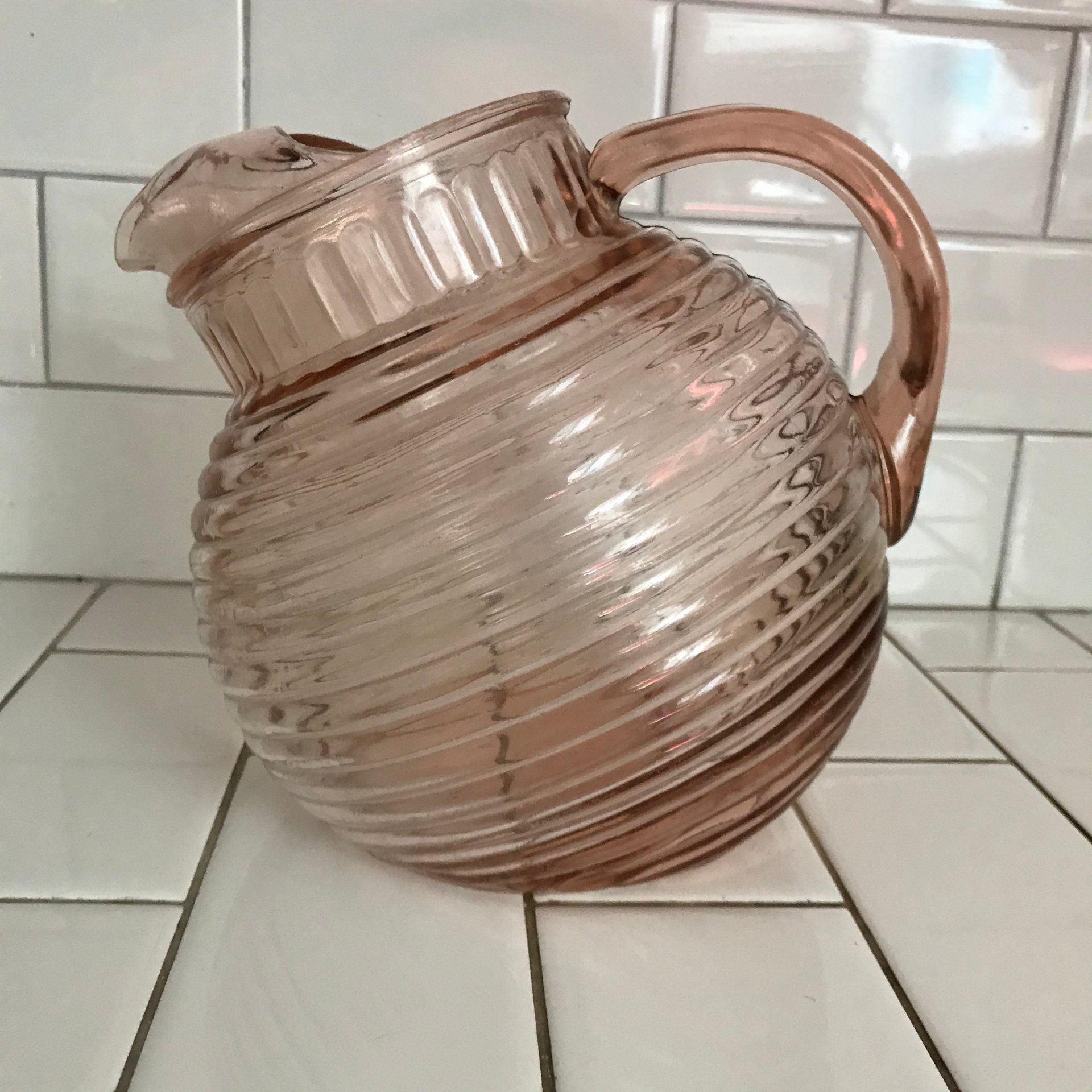 https://www.truevintageantiques.com/wp-content/uploads/2021/05/vintage-tilt-ball-pitcher-pink-ribbed-glass-depression-era-collectible-display-farmhouse-cottage-60990b686-scaled.jpg
