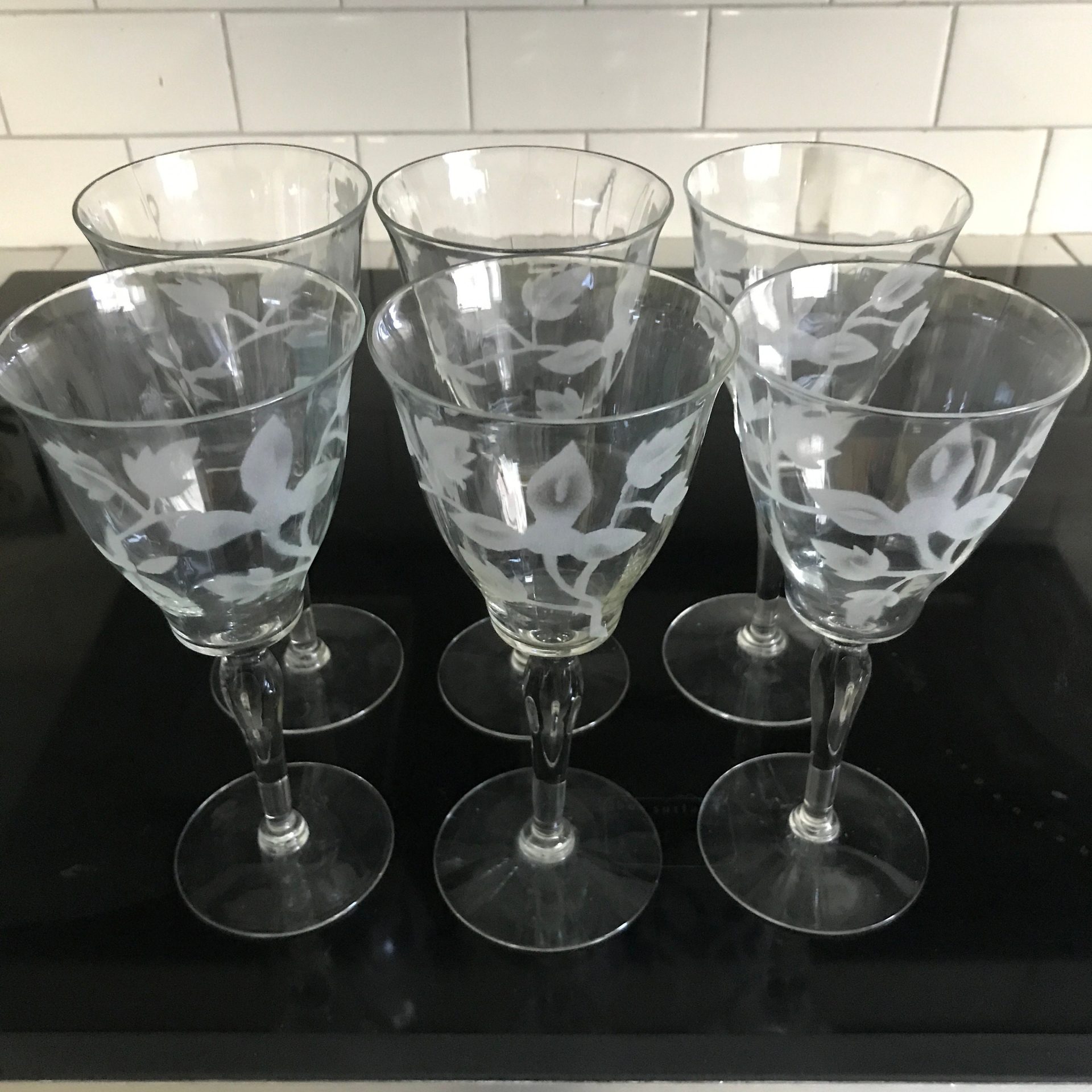 https://www.truevintageantiques.com/wp-content/uploads/2021/11/vintage-set-of-6-crystal-wine-glasses-stemware-barware-collectible-crystal-drinkware-display-floral-etched-pattern-61a295341-scaled.jpg